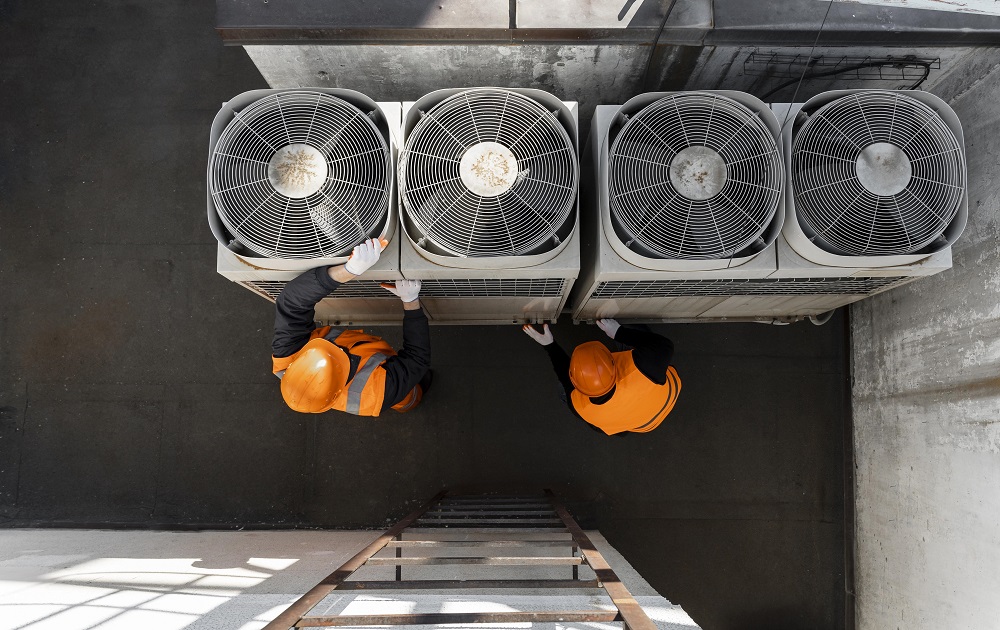 Central air conditioner technician working on equipment